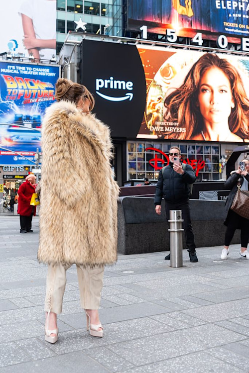 JLo looking at a billboard for her new movie