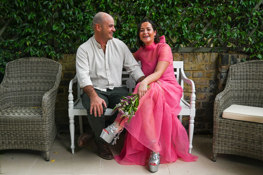 Woman in pink dress with a man smiling 