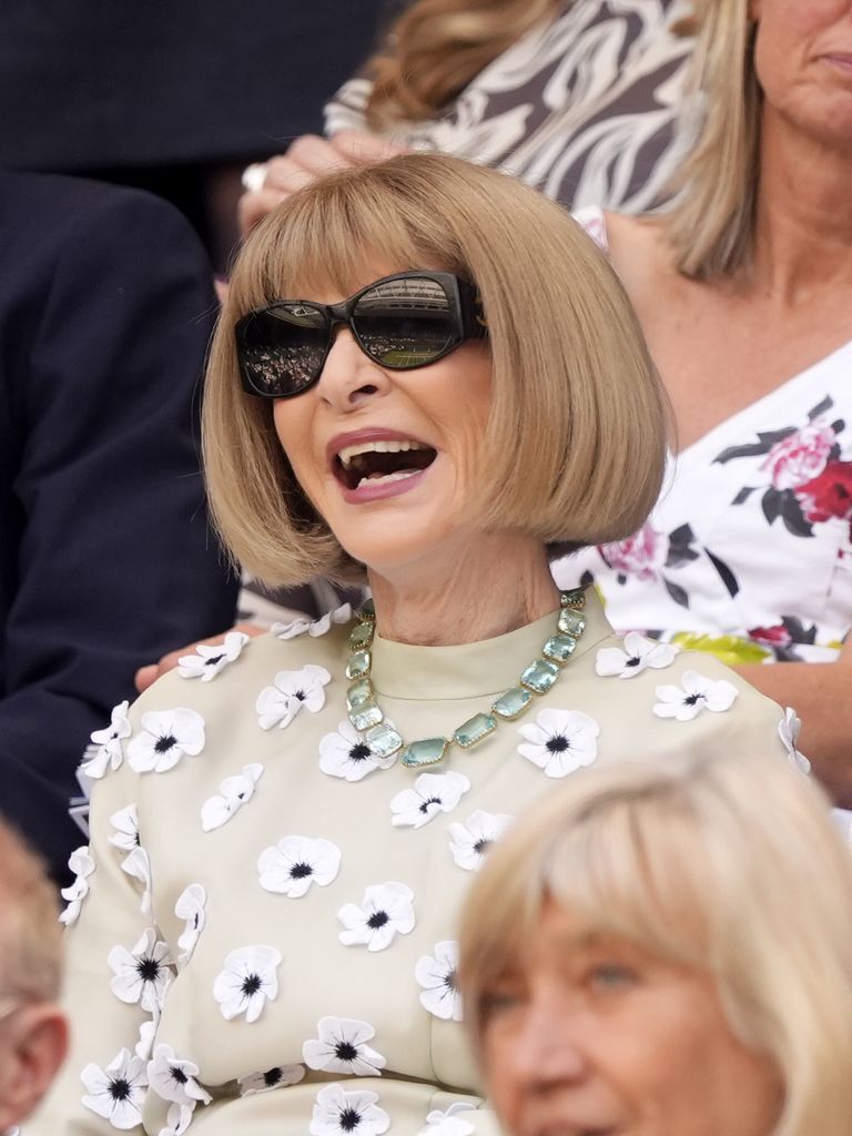 Dame Anna Wintour laughing in floral top
