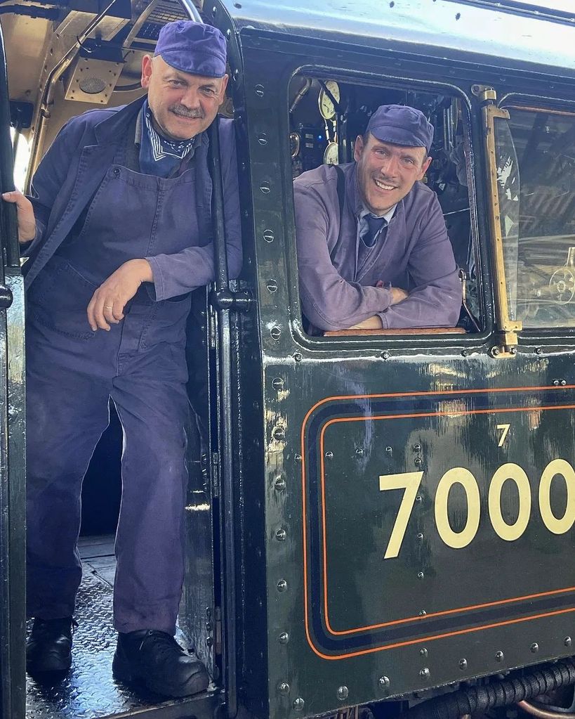 two workers on the steam train