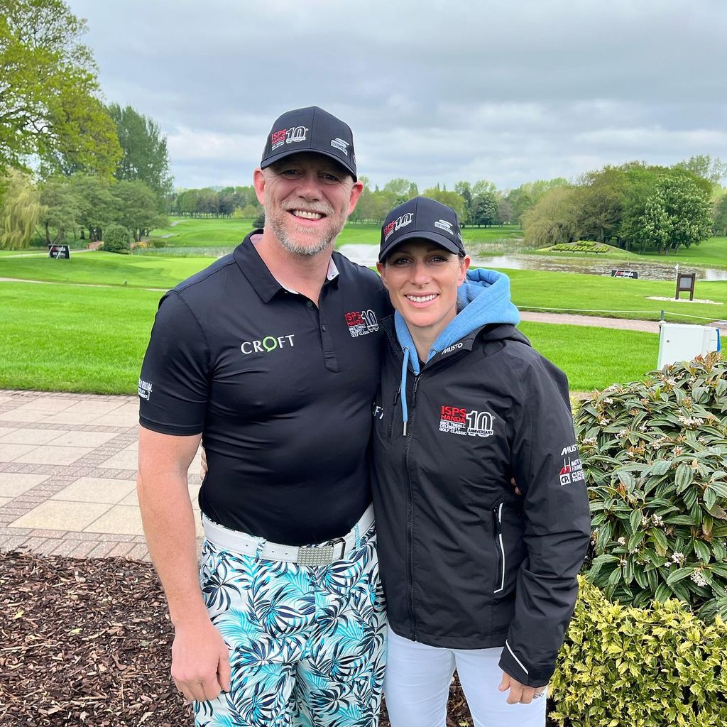 couple posing at golf course in caps 