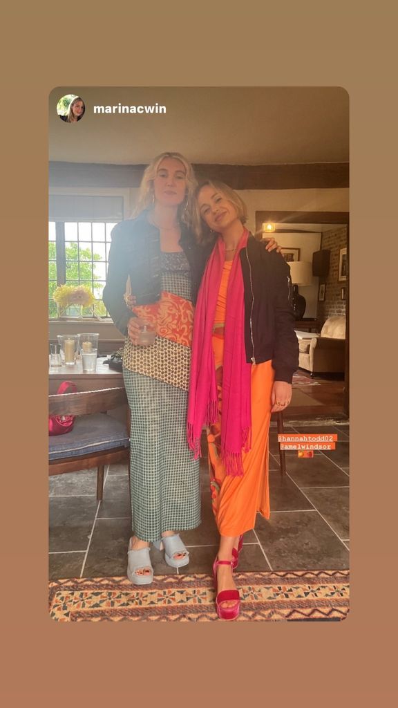 Amelia Windsor in an orange dress and pink scarf