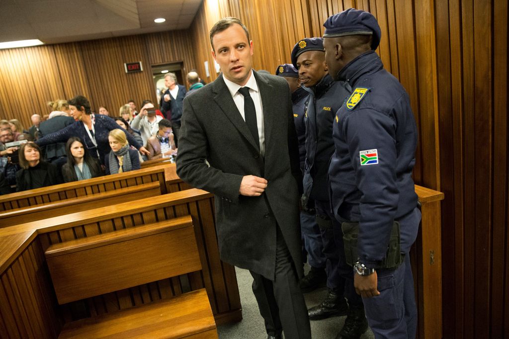PRETORIA, SOUTH AFRICA - JULY 06: South African Paralympic athlete Oscar Pistorius arrives with security at the North Gauteng High Court to attend summary judgement on his trial on July 6, 2016 in Pretoria, South Africa.The Paralympic athlete killed his girlfriend on Valentines Day of 2013, when he fired a gun four times through a locked toilet door at his Pretoria home. (Photo by Marco Longari / AFP / Pool/Anadolu Agency/Getty Images)