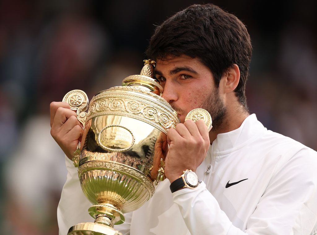 Carlos Alcaraz of Spain with the Men's Singles Trophy following his victory in the Men's Singles Final against Novak Djokovic of Serbia on day fourteen of The Championships Wimbledon 2023 at All England Lawn Tennis and Croquet Club on July 16, 2023 in London, England