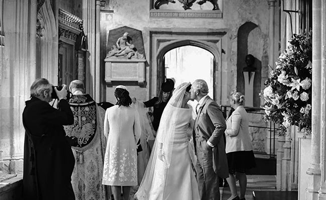 The bride was pictured kissing her father-in-law King Charles