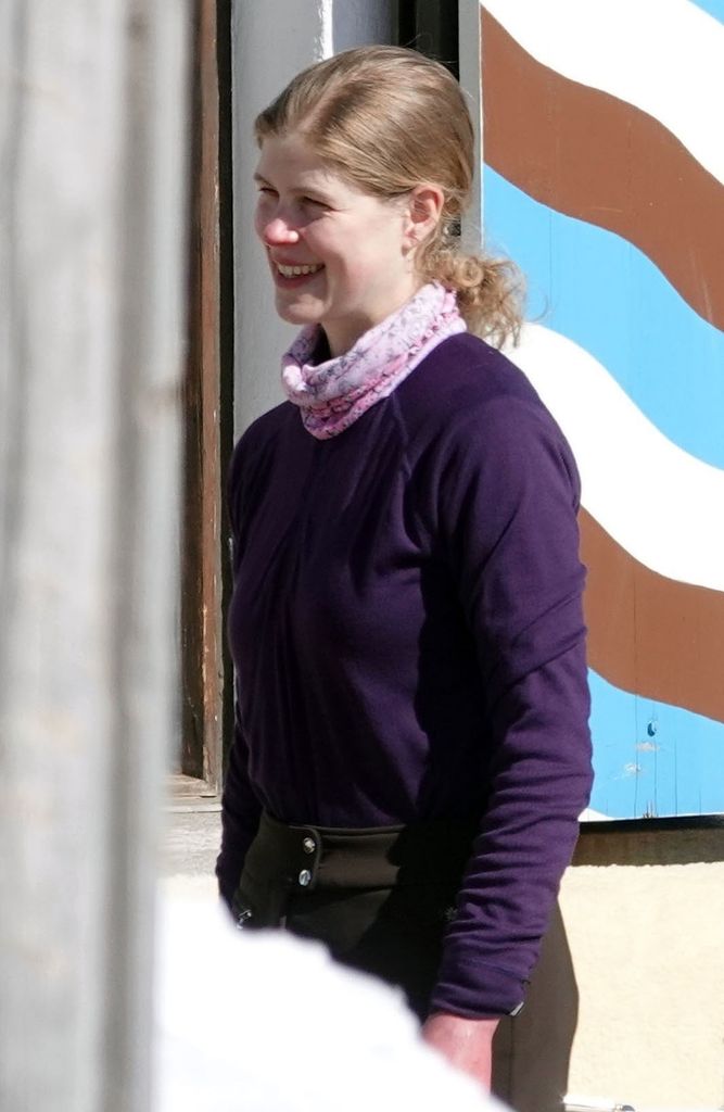 Lady Louise Windsor in a purple jumper and brown trousers