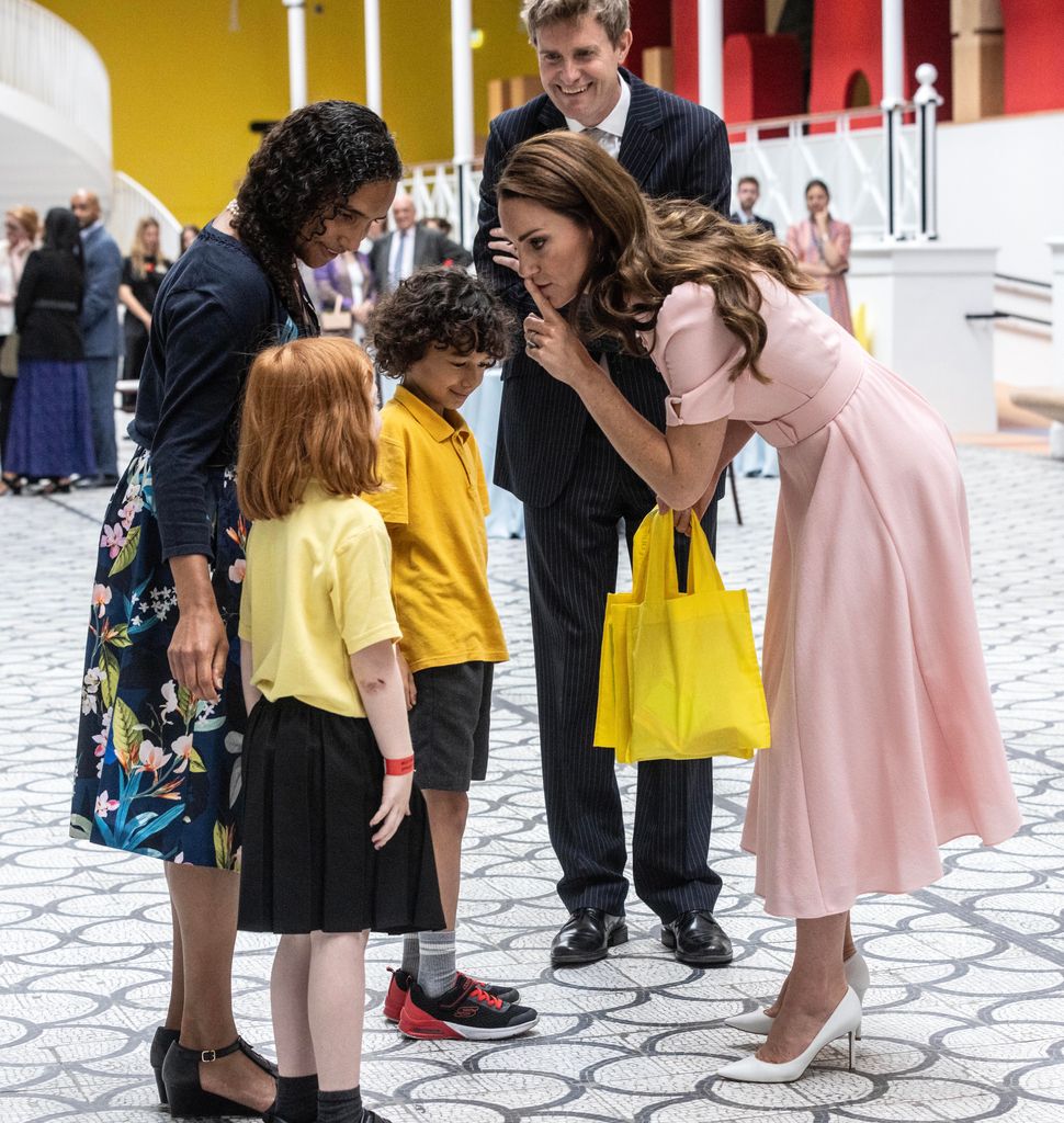 Princess Kate is given a goodie bag for her children as she officially opens The Young V&A