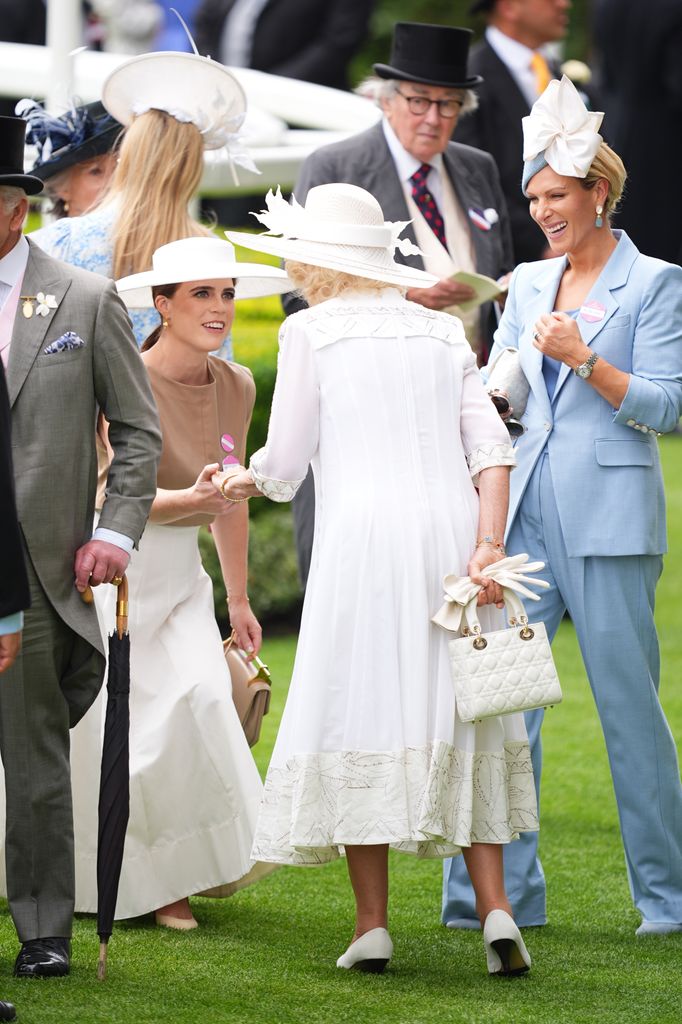 Princess Eugenie performs a curtsy as she greets Queen Camilla