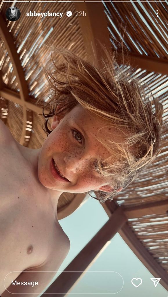 young boy staring down at camera