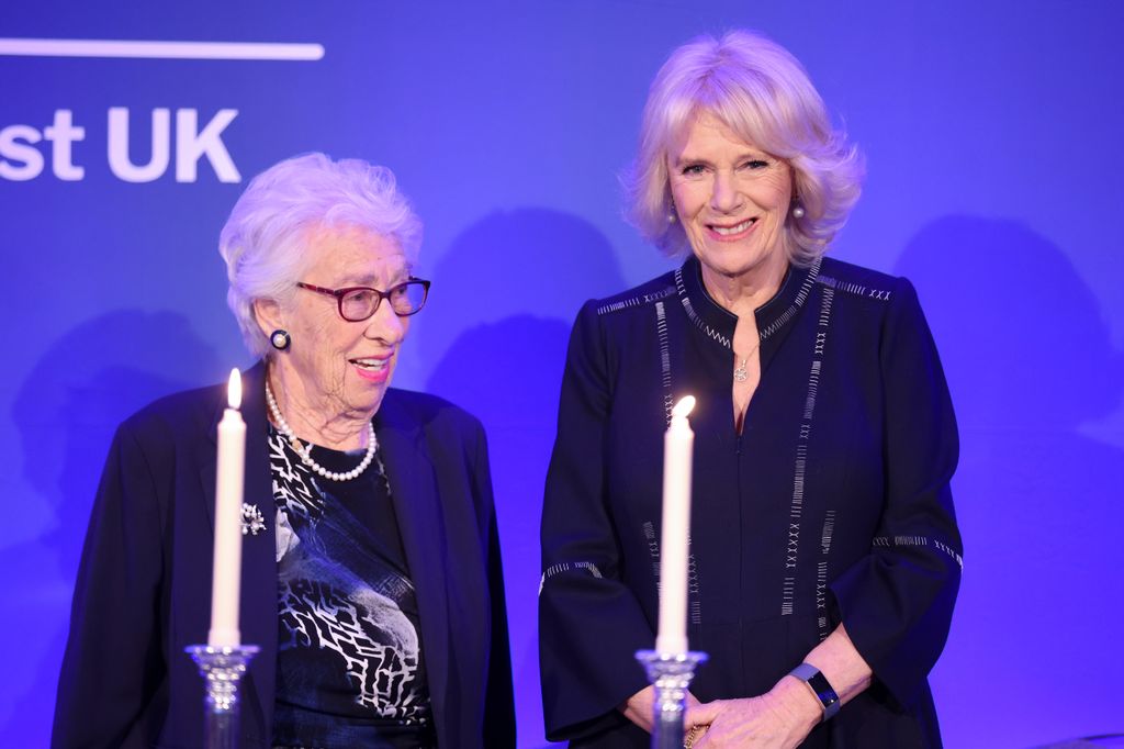 Eva Schloss MBE, step-sister of Anne Frank and Honorary President of the Anne Frank Trust UK and Camilla, Duchess of Cornwall take part in a candle lighting ceremony during a reception to mark Holocaust memorial day and the 75th publication of Anne Franks diary for the Anne Frank Trust at the InterContinental Hotel on January 20, 2022 in London, England. The Diary of Anne Frank was first published in Dutch in June 1947, three years after the death of its young author at Bergen-Belsen concentration camp. Since then it has been published worldwide in 70 different languages and is widely regarded as one of the most influential pieces of literature of the 20th century. (Photo by Chris Jackson - Pool/Getty Images)