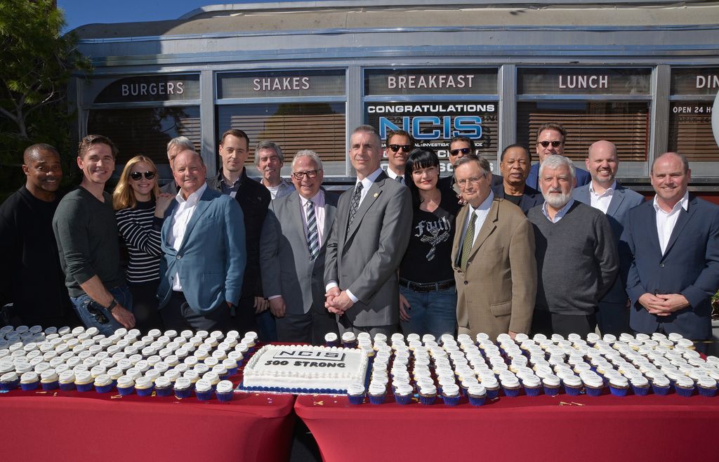 Rocky Carroll, Brian Dietzen, Emily Wickersham and Mark Harmon, executive producer Mark Schilz, actor Sean Murray, executive producers George Schenck and Gary Glasberg, NCIS Director Andrew Traver, actors Michael Weatherly, Pauley Perrette, executive producer Scott Williams, David McCallum and executive producers Chas. Floyd Johnson, Mark Horowitz, Frank Cardea, Glen Geller and David Stapf attend the cake cutting celebration for "NCIS" 300th episode on February 9, 2016 in Valencia, California