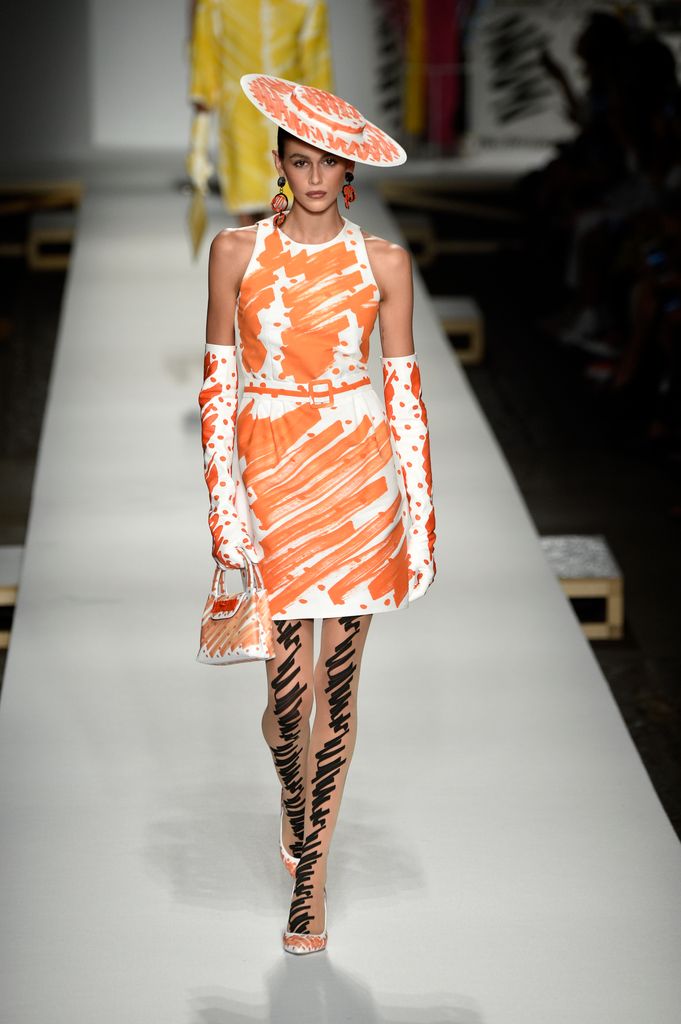kaia gerber in painted orange look on the runway