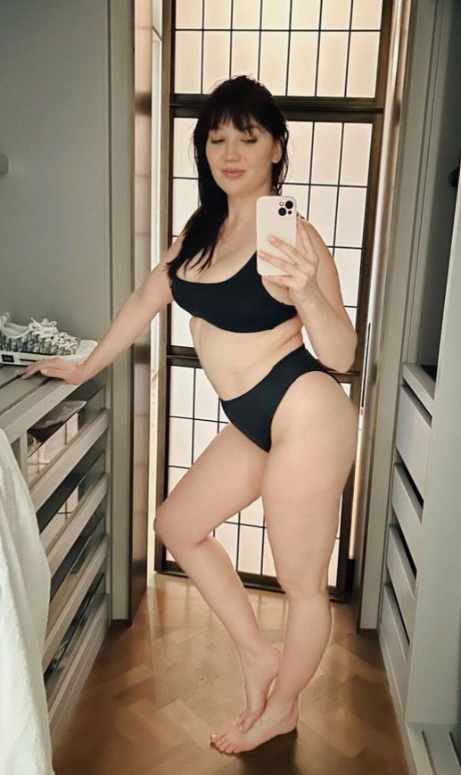 Daisy Lowe posing in black bikini