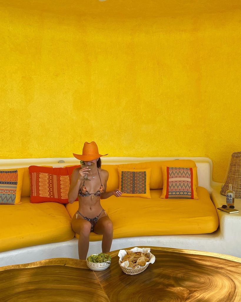 A photo of Kendall Jenner wearing a string bikini and orange cowboy hat
