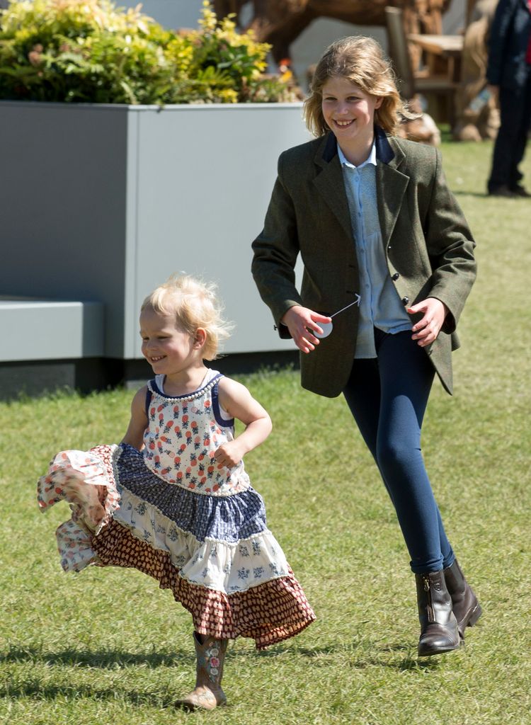 Isla plays chase with her relative Lady Louise Windsor at the Royal Windsor Horse Show in May 2015. What a pretty dress!