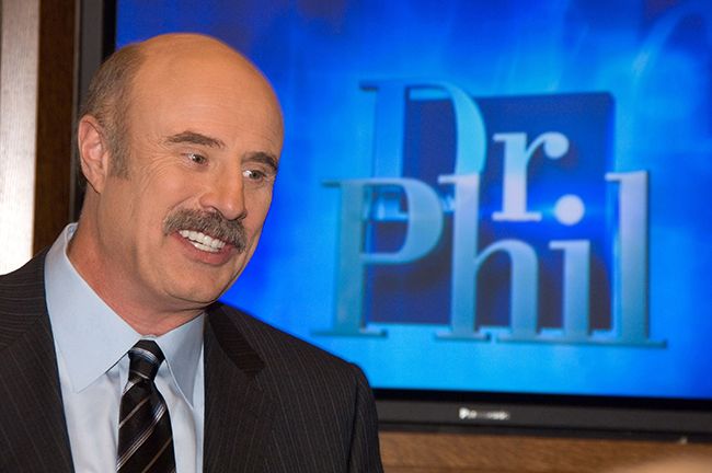 Dr Phil standing in front of screen on chat show