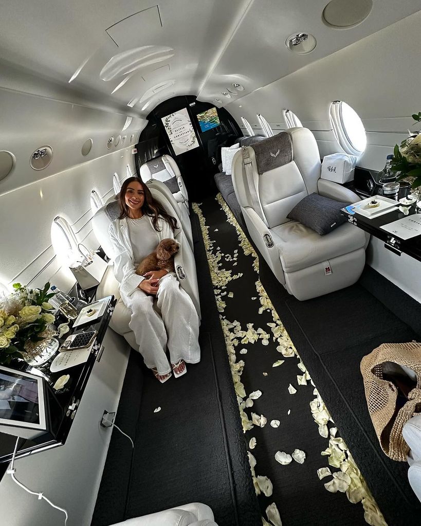 Olivia Culpo sat in a private jet with a dog on her lap