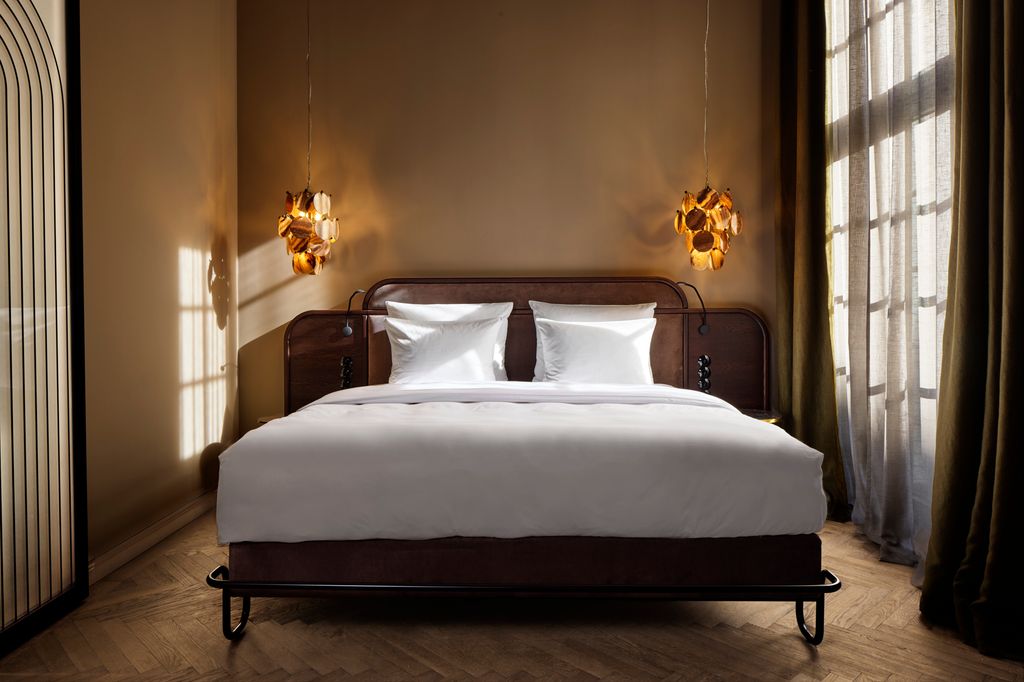 Telegraphenamt hotel in Berlin view of double bed with art deco lighting 