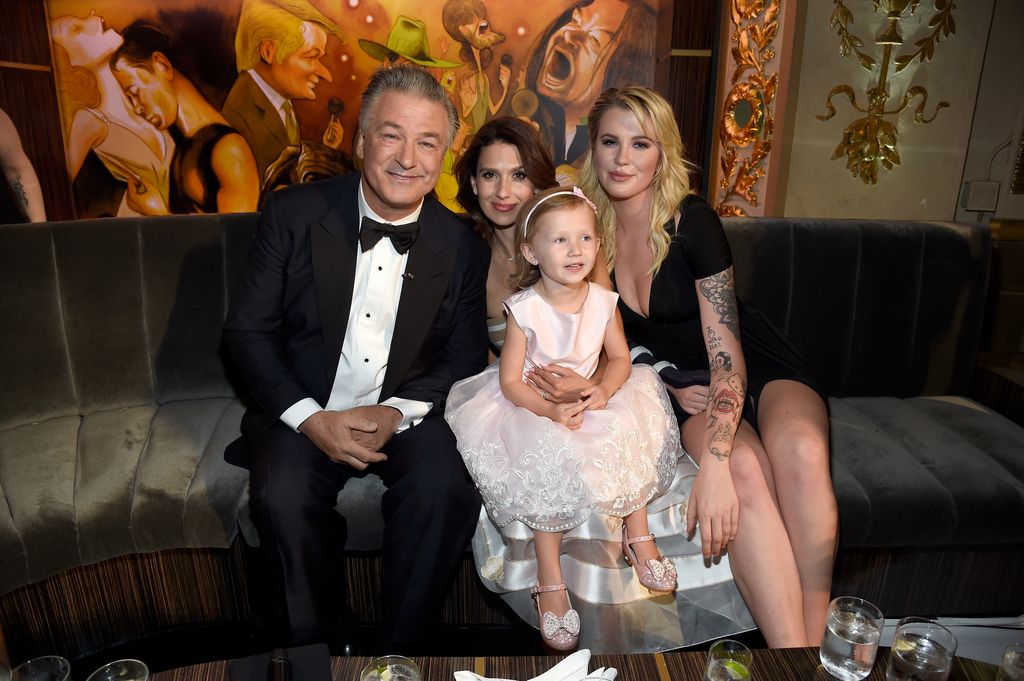 photo of alec baldwin hilaria baldwin carmen baldwin and ireland baldwin sitting on a couch