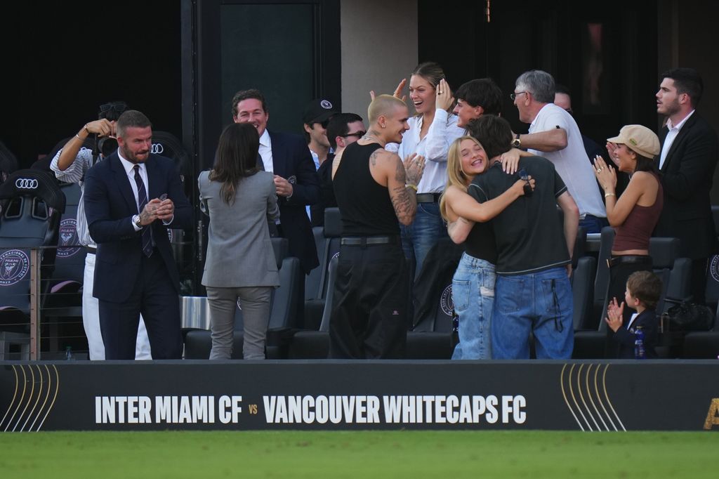 The Beckhams hugging on football stands