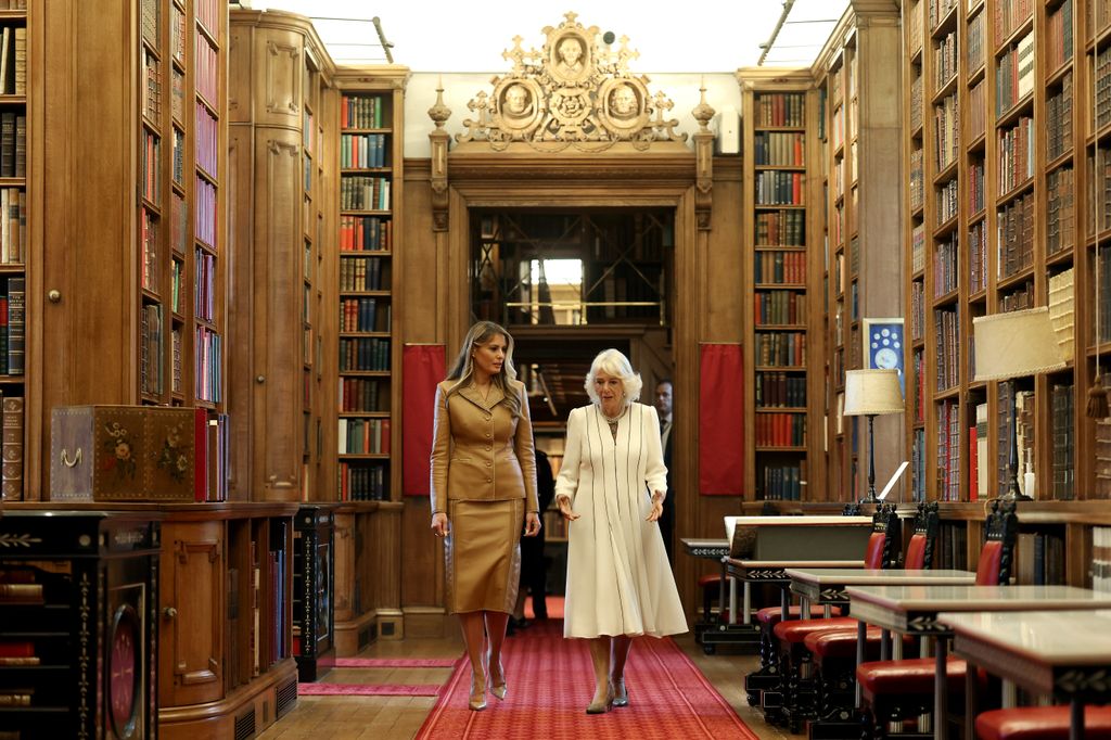 Melania Trump and Queen Camilla walking in a library
