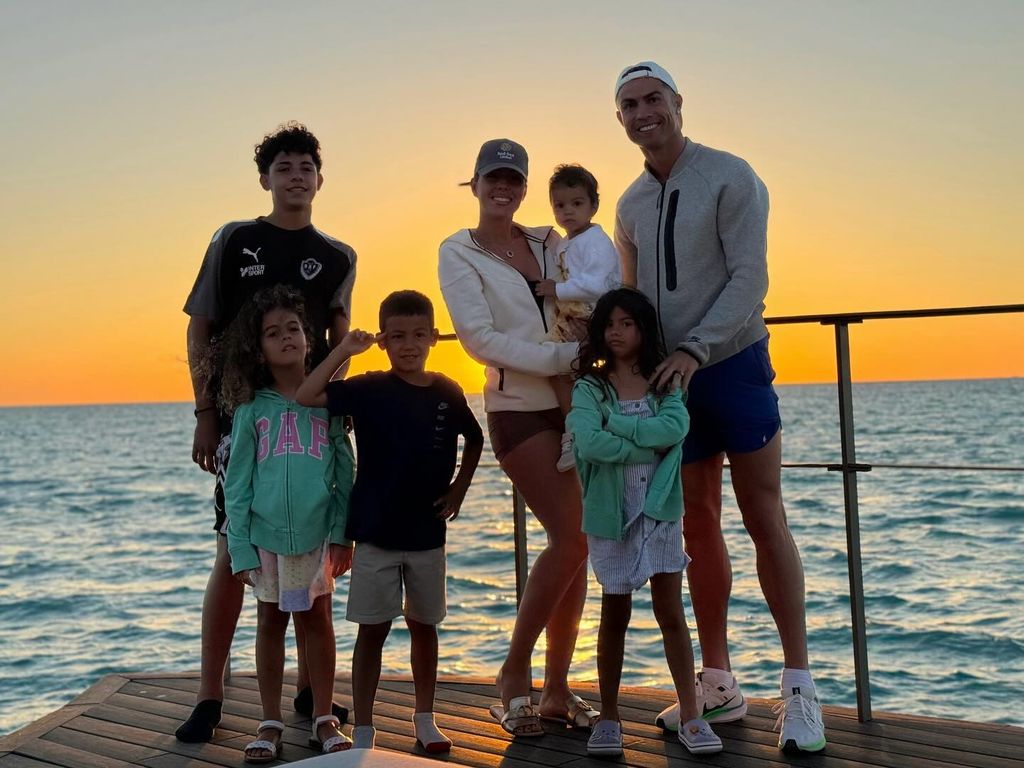 family in front of a sunset