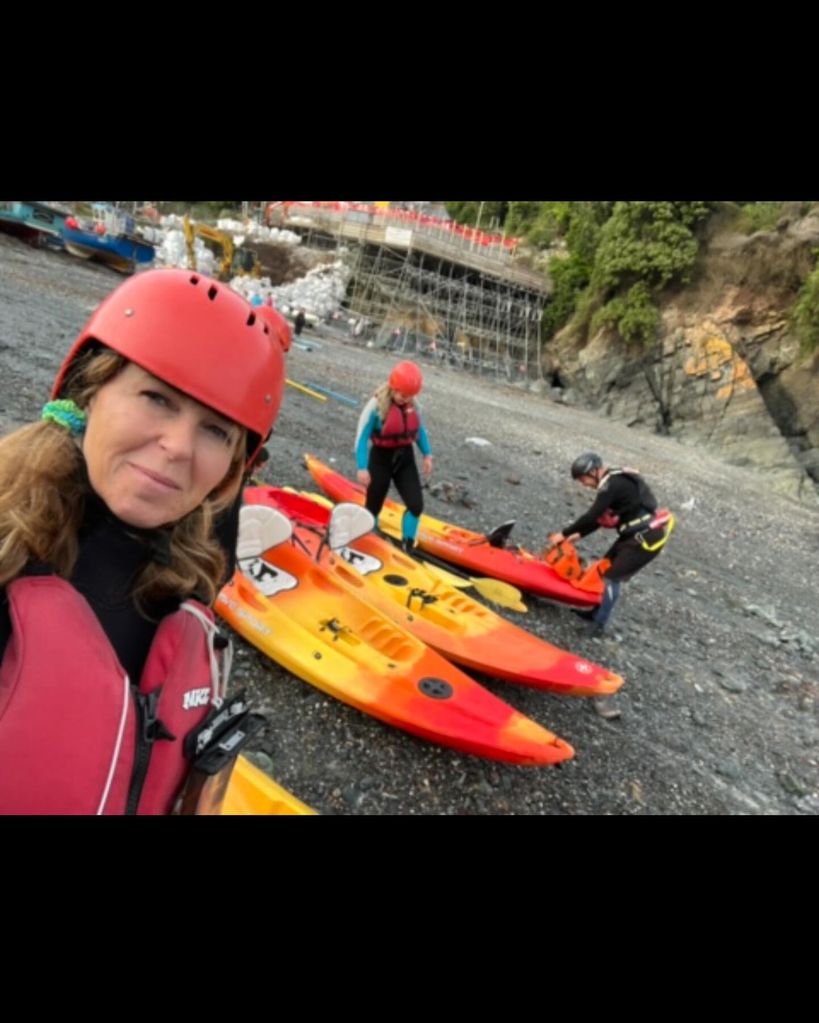 A photo of Kate Garraway and paddleboards 