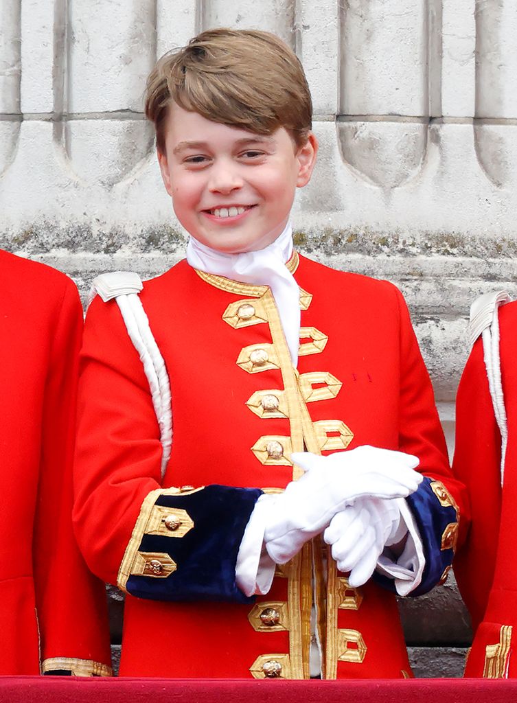 Prince George smiles in red uniform