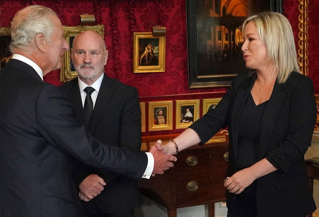 Britain's King Charles III shakes hands with Northern Ireland's Deputy First Minister and Irish republican Sinn Fein party Northern Leader Michelle O'Neill