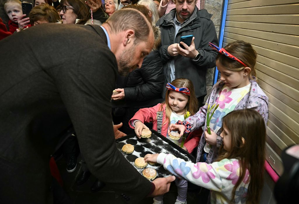 William distributes to well-wishers the Welsh Cakes made by himself and Catherine