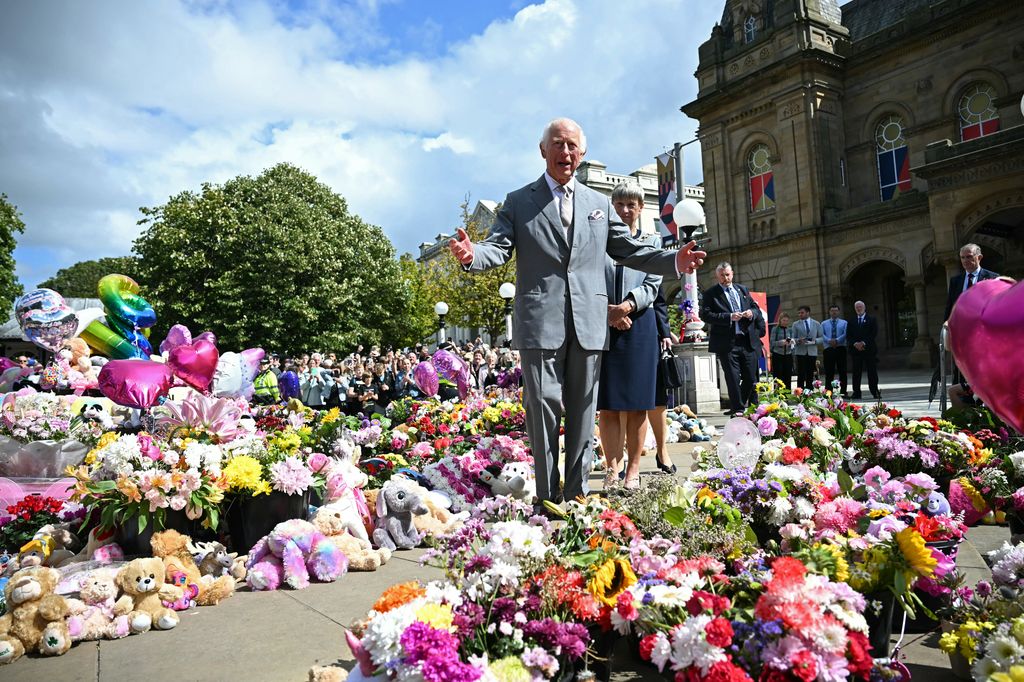 charles viewing floral tributes in Southport 