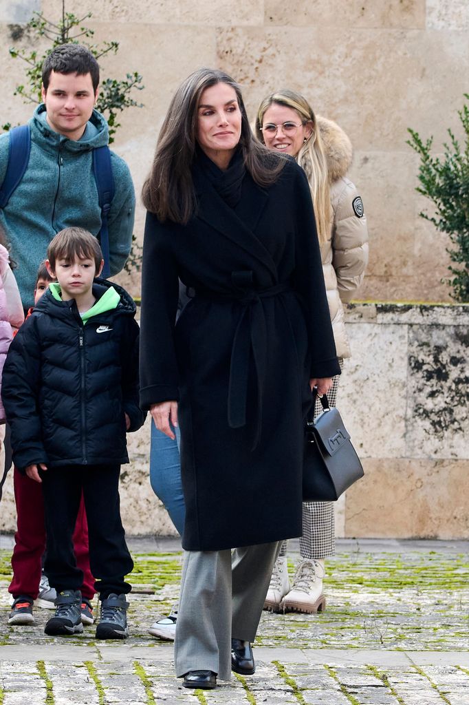 Letizia layered up for the cold weather in a stylish black coat