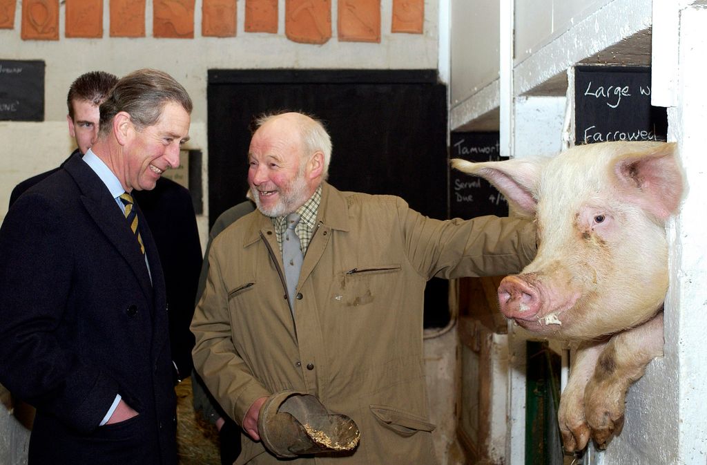 charles with a farmer and a pig