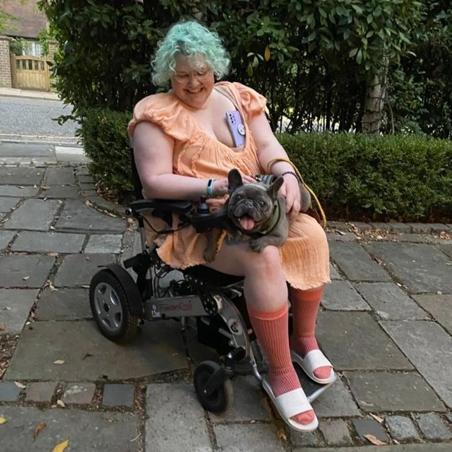Jonathan Ross daughter Betty in a wheelchair cuddling her dog
