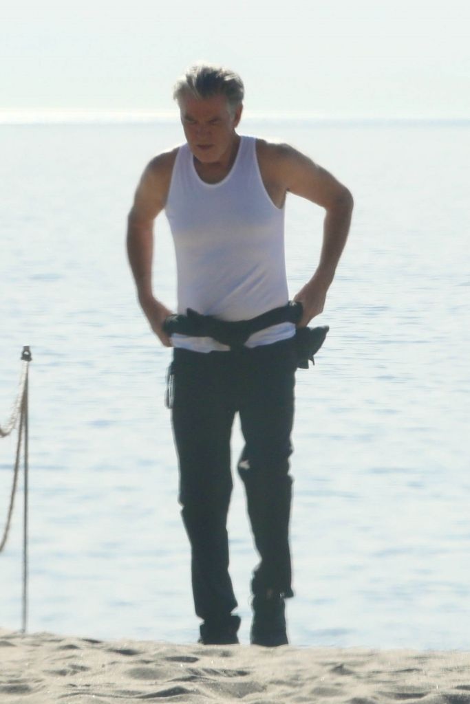 Pierce shows off his trim physique during his beach stroll 