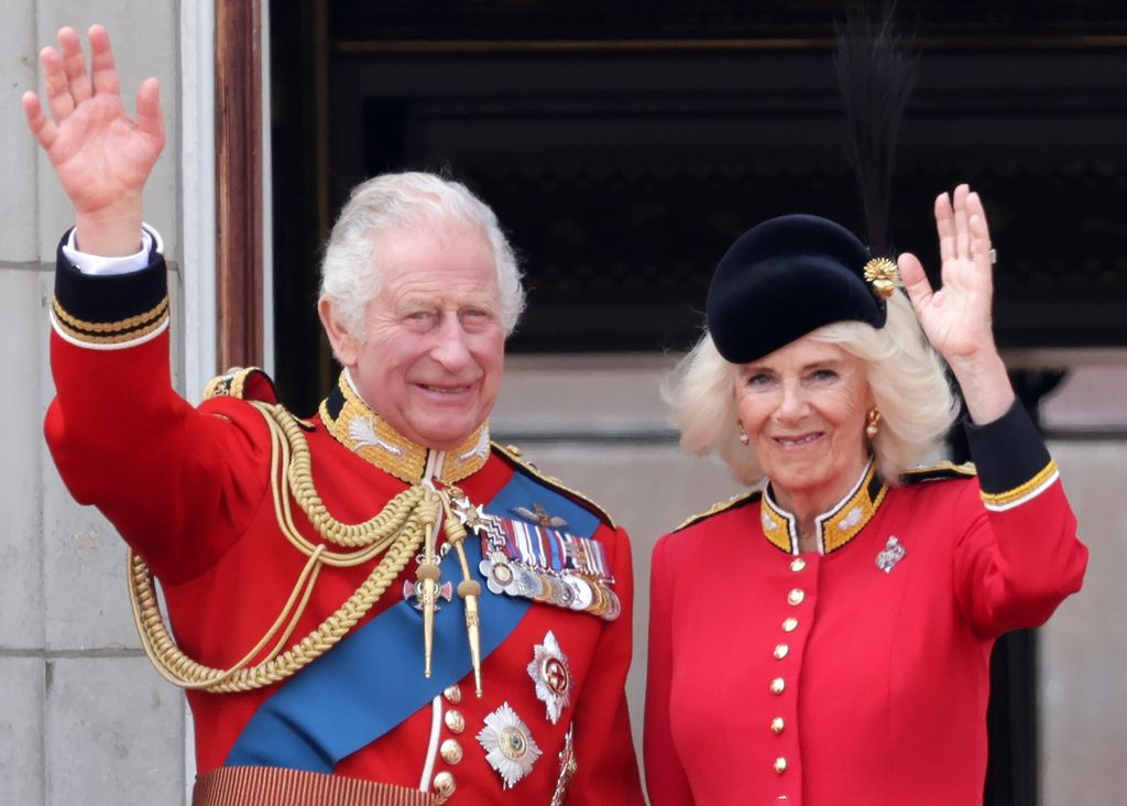 A photo of King Charles and Queen Camilla waving on the balcony of Buckingham Palace 