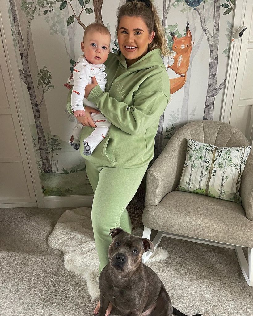 Georgia Bell holding her son in his nursery