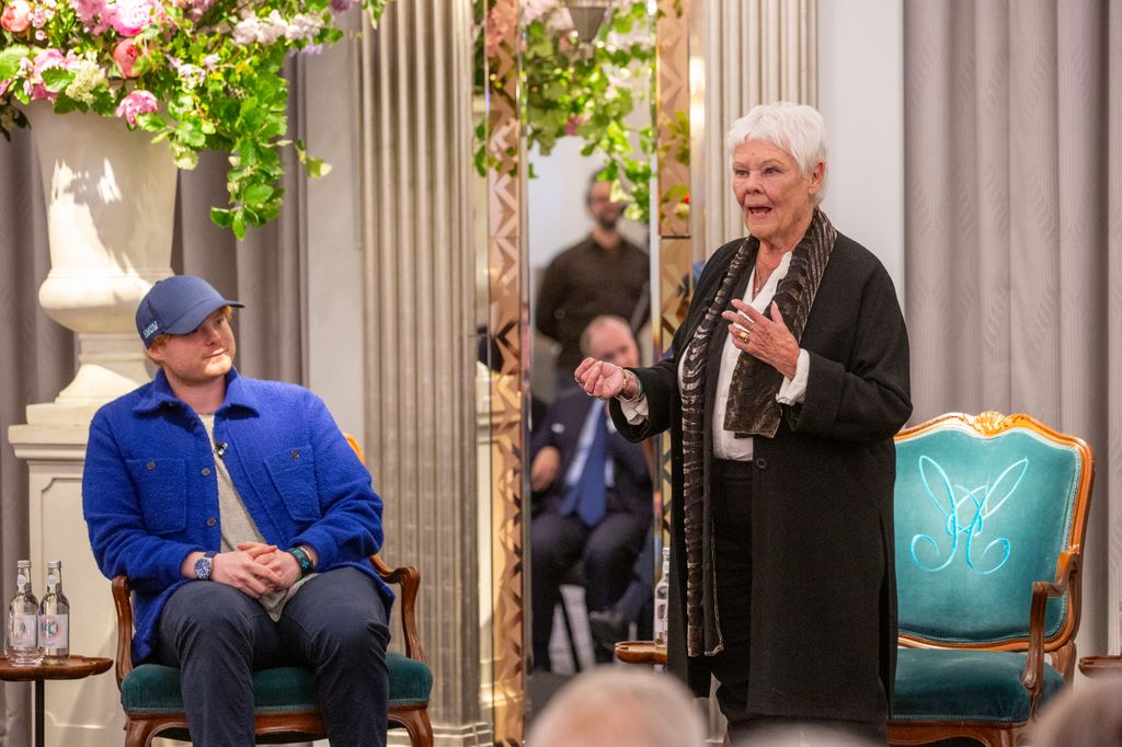 Dame Judi Dench standing next to her grandson 