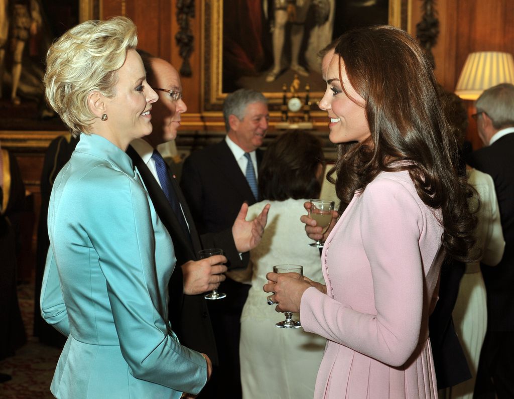 Catherine, Duchess of Cambridge talks to Princess Charlene of Monaco during a reception in the Waterloo Chamber