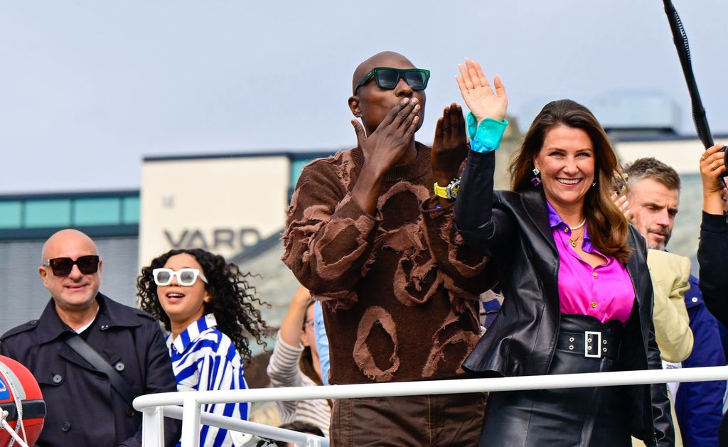 Durek Verrett blows a kiss from boat while Martha Louise waves