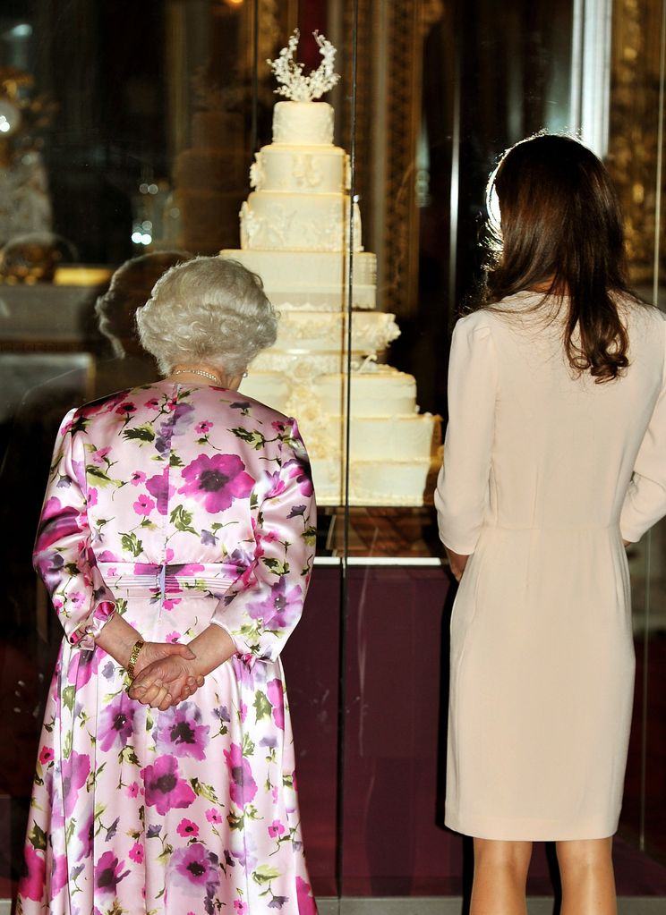 Queen Elizabeth ll and Princess Kate viewed the royal wedding cake on display at Buckingham Palace)
