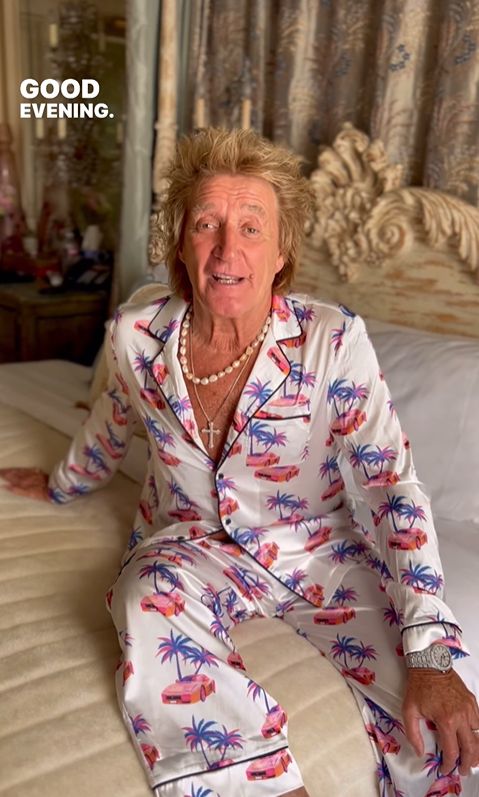 Rod Stewart in pyjamas sat on a bed