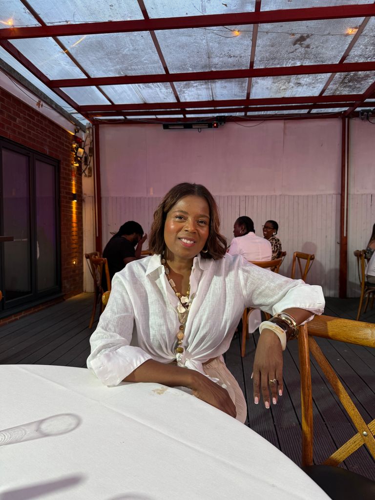 Woman in a white shirt sitting at a table
