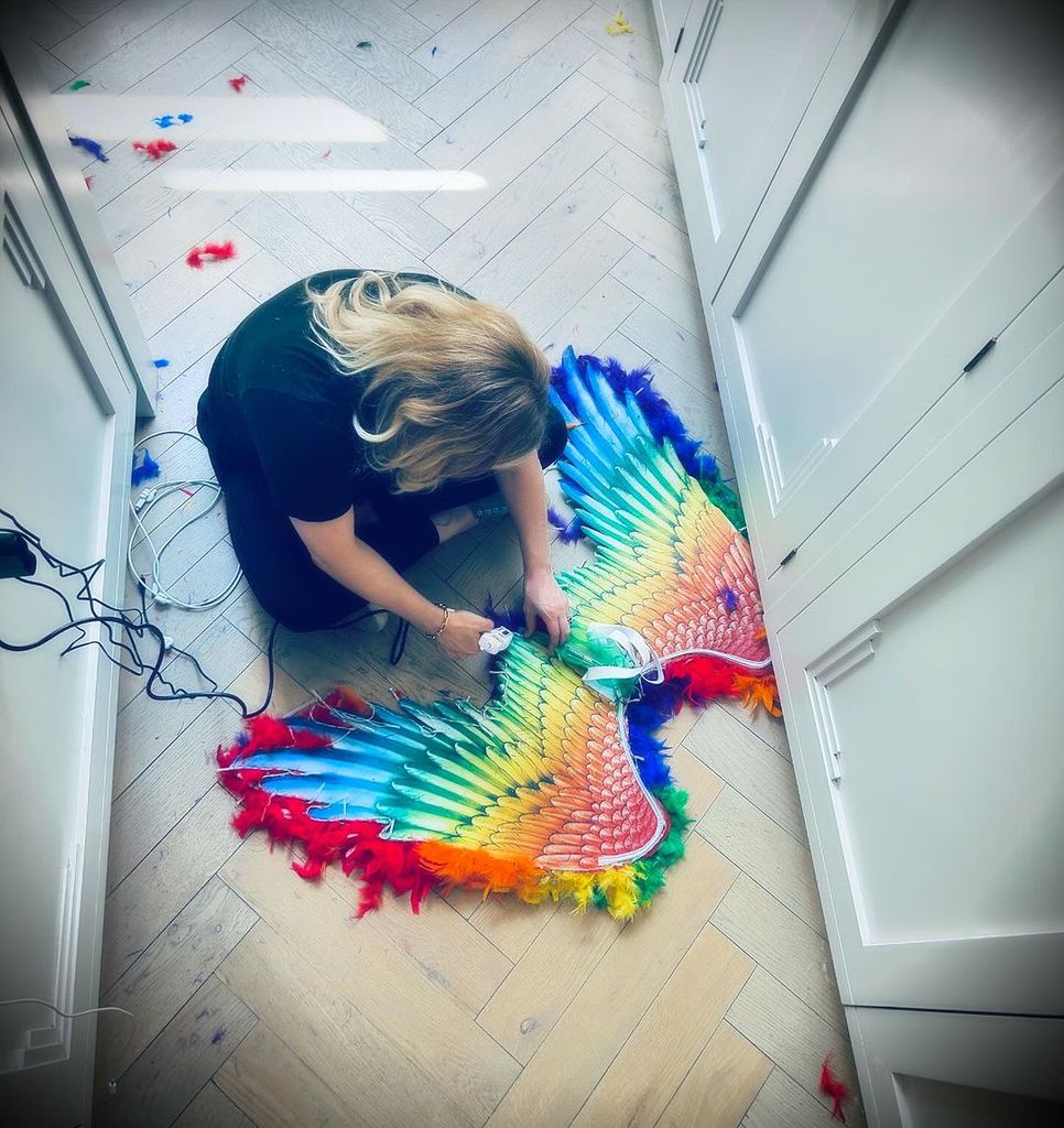 Georgia glues rainbows wings together on kitchen floor 