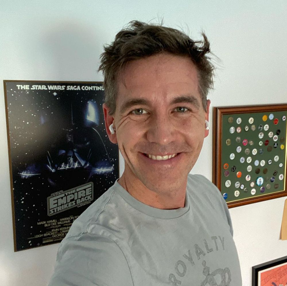 Brian Dietzen in front of a Star Wars poster