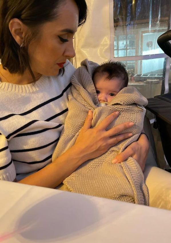Janette Manrara holding a swaddled baby