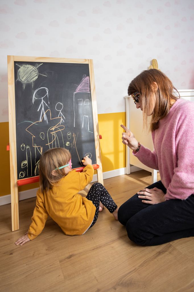 Mother scolding her little daughter while playing together at home. Childhood and motherhood concept.
