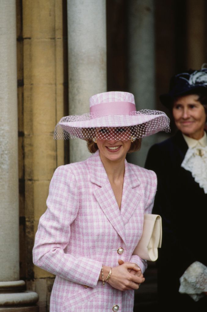 British Royal Diana, Princess of Wales (1961-1997), wearing a pink-and-white checked coatdress with a matching wide-brim hat with a pink bow and white veil, 