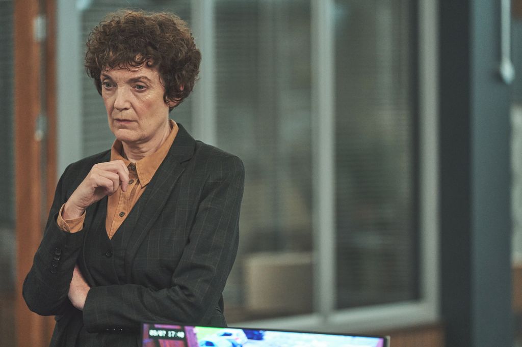 Woman with brunette hair standing in office