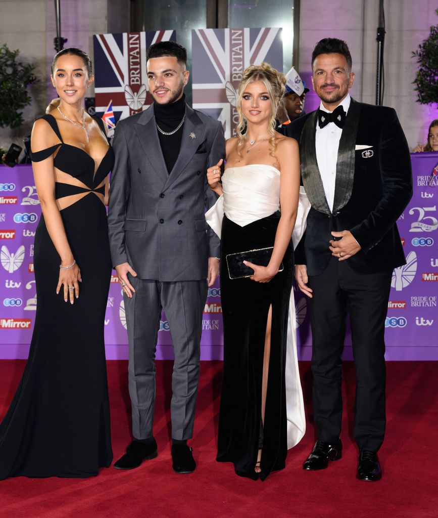 family posing on the red carpet 